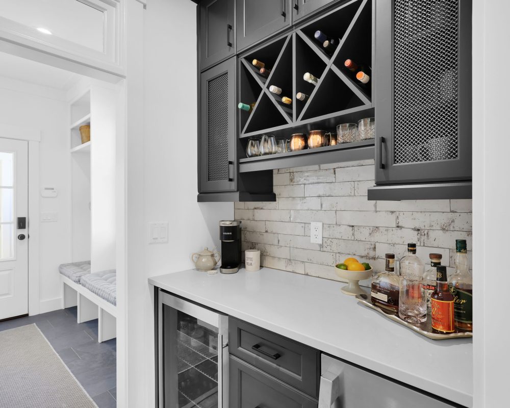 Wine storage cabinetry with black finish and wine bottle racks in a contemporary kitchen scene.