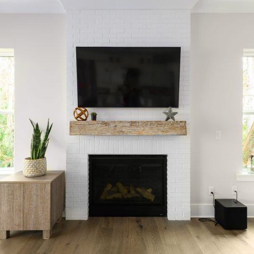 Bright living room with a modern fireplace and wall-mounted TV.