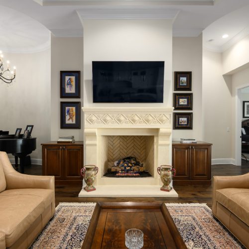 Bright and inviting living room with a modern fireplace, wall-mounted TV, and elegant decor.
