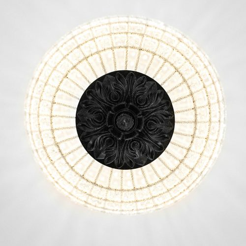 Chandelier featuring a black central element surrounded by a white, circular, grid-like structure, hanging from the ceiling.