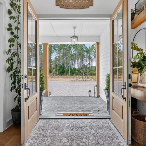 Bright, welcoming entrance with natural light and greenery outside.