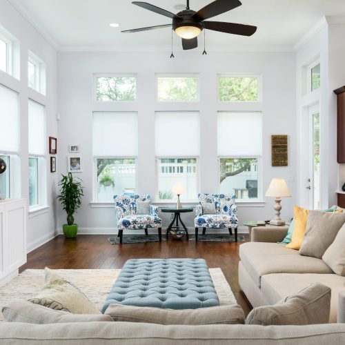 Bright living room with large windows, white walls, and contemporary furniture.