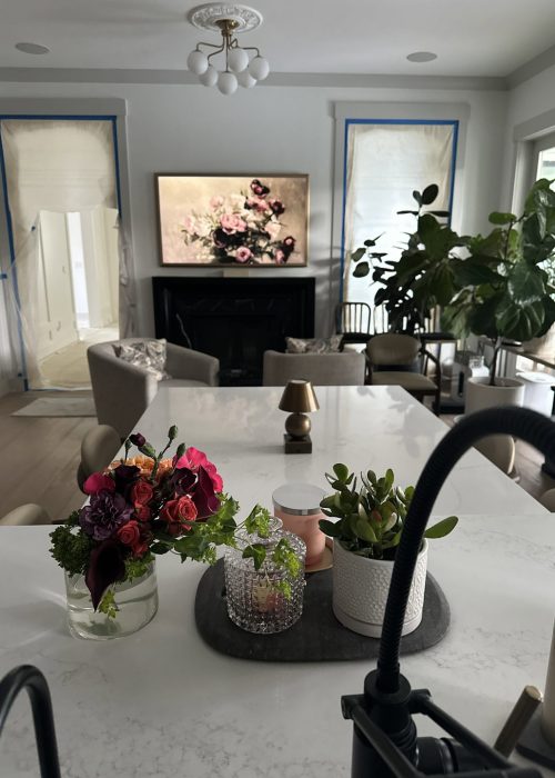 Bright and inviting living room featuring contemporary decor, large windows with natural light, and a cozy fireplace, creating a warm and welcoming atmosphere.